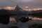 The coming sunset with dramatic alpenglow at the high mountain lake Stelisee and Matterhorn