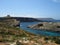 COMINO, MALTA - Apr 27, 2014: View of Santa Marija Tower, standing guard over the cliffs and blue sea of the island of Comino