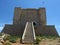 COMINO, MALTA - Apr 27, 2014: View of Santa Marija Tower, standing guard over the cliffs and blue sea of the island of Comino