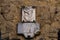 A commemorative stone with on top a rampant lion in San Gimignano