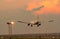 Commercial airline. Passenger plane landing at airport with beautiful sunset sky and clouds. Arrival flight. Airplane flying