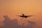 Commercial airline. Passenger plane landing at airport with beautiful sunset  sky and clouds. Arrival flight. Airplane flying