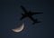 Commercial Airliner and Crescent Moon at Dusk