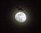 Commercial Airliner Passing a Full Moon at Night