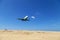 Commercial airplane landing above sea and clear blue sky over beautiful scenery nature background location at mai khao beach