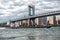 Commercial cargo vessel ship at Eat River in New York City under Manhattan Bridge