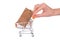 Commercial consumerism concept. Side profile close up photo of pushcart with pricetag inside hand holing pushing cart isolated on