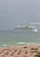 Commercial cruise ship leaving port and a Ft. Lauderdale  beach on a stormy, misty afternoon