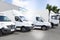 Commercial delivery vans park in transport parking place of transporting carrier shipping service