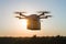 Commercial drone carries delivery parcel through clear sky