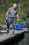 Commercial fish farmer holding scoop and bucket