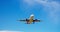 A commercial jet flying through a clear blue sky