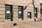 Commercial or municipal building with basement windows replaced with glass brick blocks for security, crumbling dressed limestone