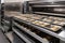 commercial oven with a range of trays and baking pans, ready to prepare variety of baked goods