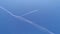 Commercial plane flying on the blue sky diagonally into the frame. Airplane aviation airport contrail the clouds.