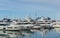 Commercial seaport Marine Station of Sochi.  Ships, yachts in city center on pier reflected on blue surface of Black Sea