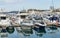 Commercial seaport Marine Station of Sochi.  Ships, yachts in city center on pier reflected on blue surface of Black Sea