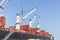 Commercial ship with cranes while unloading container to the ship