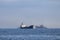 Commercial ships moving on the route. Tugboats towing the old rusty wreck ship for ship breaking and tankermoving in oppodite dire