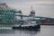 Commercial tugboat Delaware in main channel, Port of Los Angeles harbor, with gantry cranes, shipping terminals