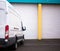 Commercial van for transporting cargo waiting by the warehouse g