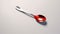 Commissioned Red Spoon With Silver Trim On Smooth Surface