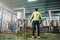 Commitment caucasian technician engineer man in safety uniform standing with pipeline, boiler tank in beverage processing