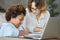 Commitment to excellence. Enthusiastic mixed race teen schoolgirl writing during a lesson with her female teacher at