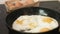 Common for a breakfast preparation of fried eggs on a cast-iron frying pan.