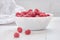 Common raspberries. Ripe red fruits in white bowl