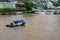 A common sight of Tugboats cruising along the famous Chao Praya River, Bangkok, Thailand.