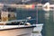 Common Tern perched on boat railing with lobster docks and skiffs on a calm morning in Maine