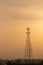 A communication cum network tower standing tall between the cityï¼Œ shot during the evening time.