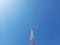 The Communication Signal Tower Rises High Into the Sky During the Hot Day