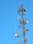 Communication Tower with Parabolic and GSM Antennas on beautiful blue sky