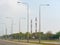 Communication transmission towers by street view over sunny blue sky