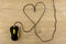 Communication with your loved ones - Valentine`s day: black mouse for notebook.the cord is laid out in the shape of a heart