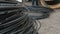 A communications engineer spins an optical cable from a large wooden cable drum.