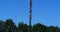 Communications mast against a sunny blue background