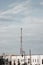 A communications tower standing high above city townhomes