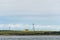 Communications towers and abandoned house on pastoral Smith Island, San Juan Islands, calm sea and cloudy day, USA