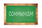 COMMUNISM text written on green school board