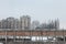 Communist housing buildings in front of an abandoned warehouse in Pancevo, Serbia, during a cold afternoon under the snow.