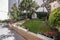 Community garden with potted geraniums, rhododendrons