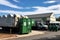 a community recycling center, with bins, containers and trucks for sorting and transporting recyclables