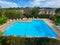 Community swimming pool and jacuzzi inside typical private condo complex.