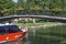 Commuter ferry boat of Stockholm in the Royal Chanel Tour, passing beneath the bridge, as seen from Djurgarden island