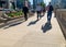 Commuters cast long summer shadows on the sidewalk during rush hour in Chicago Loop