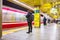 Commuters wait for the train to stop to get on at one of the subway stations in Tokyo, Japan