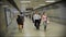 Commuters Walk through Underground Train Station